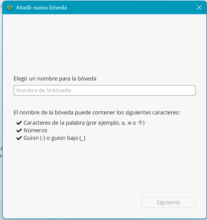 Ventana mostrando un espacio en blanco con la indicación “Nombre de la bóveda”, debajo del espacio incluye un listado con el título “El nombre de la bóveda puede contener los siguientes caracteres:”, a continuación el listado que comienza con “Caracteres de la palabra”, “Números” y “Guión (-) o guión bajo (_)”. Y en la esquina inferior derecha el botón “Siguiente”.